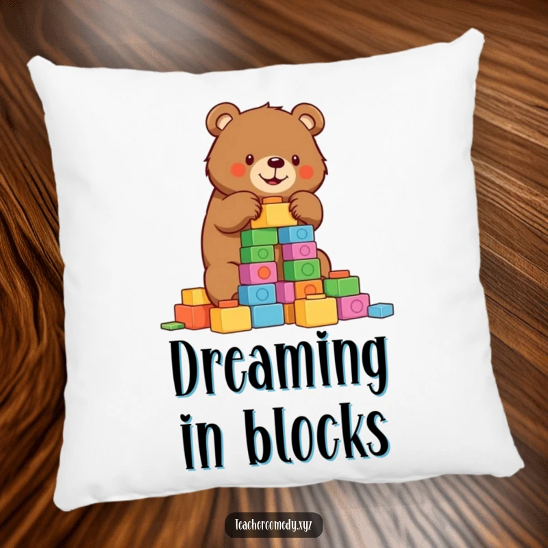 Funny bear pillow with a determined bear building a tower of colorful blocks, adding comfort and a humorous touch.